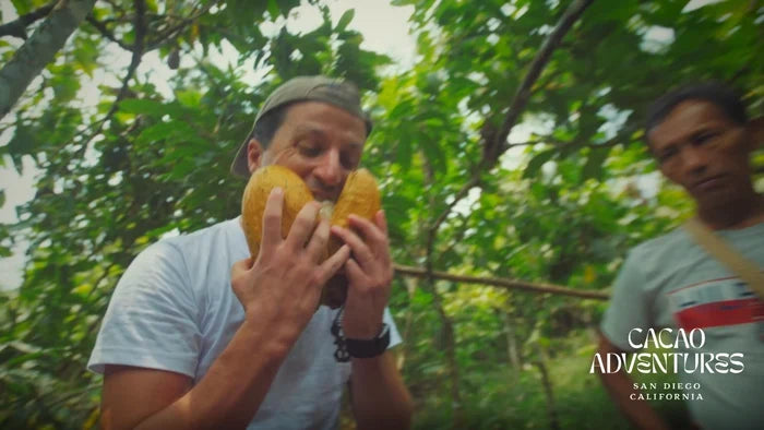 Founder of Cacao Adventures eating raw cacao fruit in the jungle.