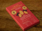 Cacao Adventures 100% Ceremonial Grade Cacao Bar red box on rustic wooden surface, High Amazon Basin Amazonas Peru, 50g