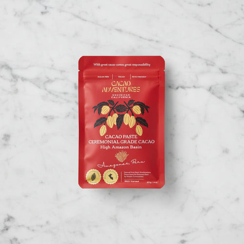 Cacao Adventures Ceremonial Grade Cacao Paste red pouch front on marble background, 227g / 8oz, High Amazon Basin Amazonas Peru, sugar-free vegan keto-friendly