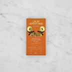 Cacao Adventures Unmilk'd Chocolate 53% cacao bar with Lucuma on white marble surface, dairy-free vegan keto-friendly, single-origin Peru