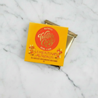 Willie's Cacao Clementina's Almonds 44% Milk Chocolate yellow box on white marble with wrapped bar behind the box, natural bean-to-bar, 50g