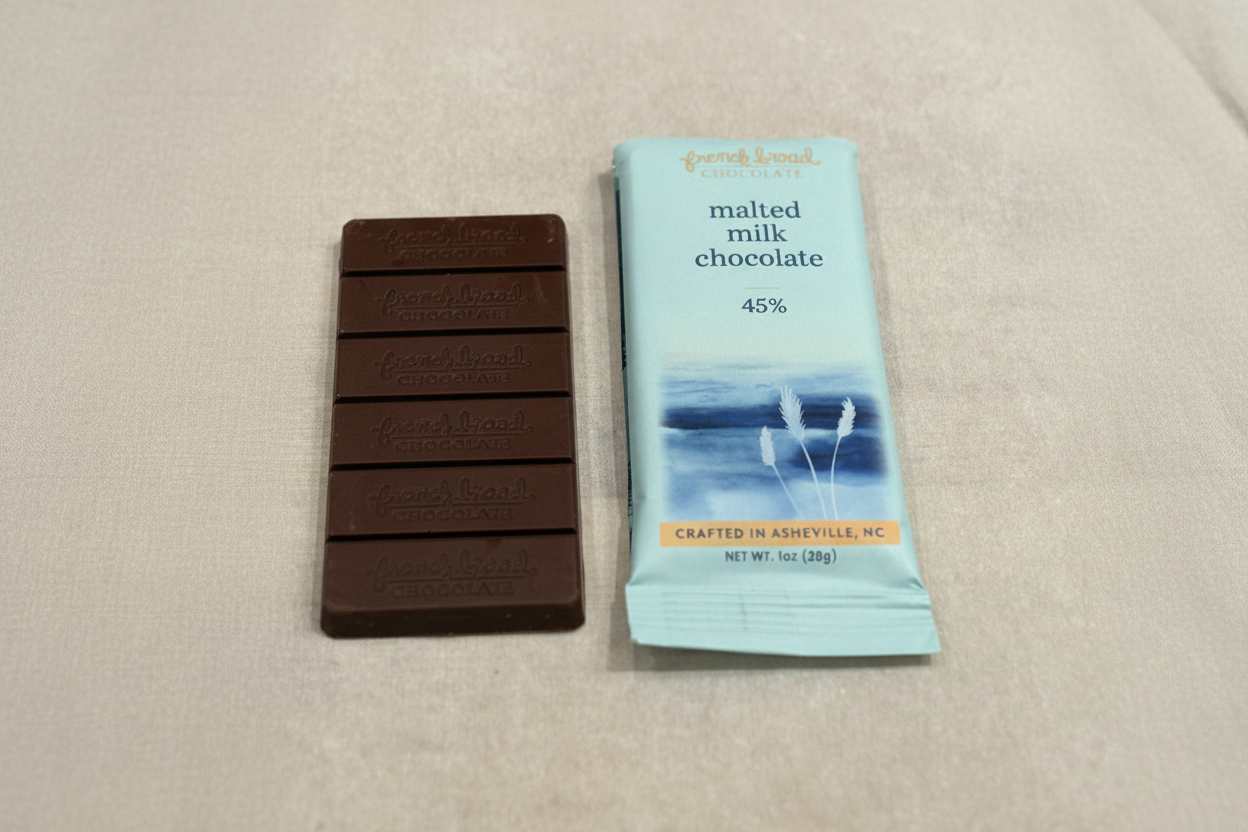 French Broad Chocolate 45% Malted Milk Chocolate bar and packaging on light linen surface