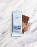 French Broad Chocolate 45% Malted Milk Chocolate bar and packaging on marble surface, crafted in Asheville NC, 1oz 28g