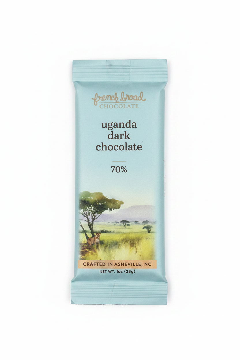 French Broad Chocolate 70% Uganda Dark Chocolate light blue packaging front on white background, single-origin Uganda, vegan dairy-free