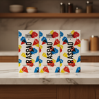 Three I Love Panama Chocolate Raspao Pineapple White Chocolate bars displayed side by side, front view, colorful packaging with illustrated raspao cups on a counter in a kitchen.