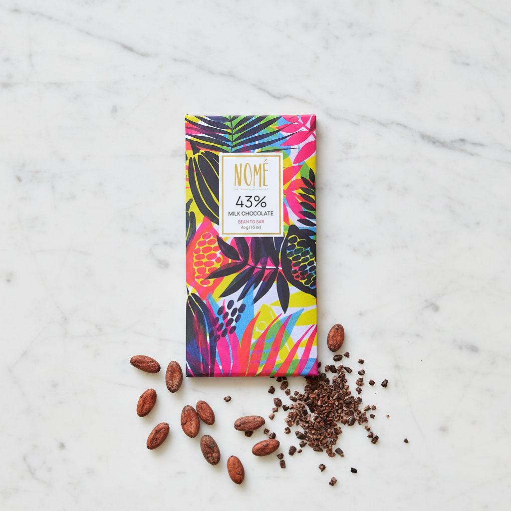 Nomé 43% Milk Chocolate bar with vibrant tropical botanical print packaging on white marble with raw cacao beans and nibs, single-origin Panama, gluten-free, bean-to-bar, 45g