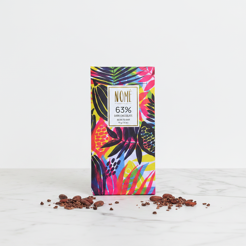 Nomé 63% Dark Chocolate bar with vibrant tropical botanical print packaging on white marble with raw cacao beans and nibs, single-origin Panama, vegan dairy-free, bean-to-bar, 45g