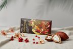 Nomé 65% Geisha Natural Dark Chocolate bar on light surface with coffee beans and pink flowers, Geisha Terroir x Nomé collaboration, specialty coffee chocolate