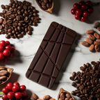 Nomé 65% Geisha Natural Dark Chocolate bar on white marble with roasted Geisha coffee beans and fresh red coffee cherries, specialty coffee chocolate, single-origin Panama