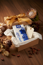 Nomé 73% Chocolate Oscuro bar styled as a gift with ribbon and wrapping, single-origin Panama, premium craft chocolate, vegan dairy-free
