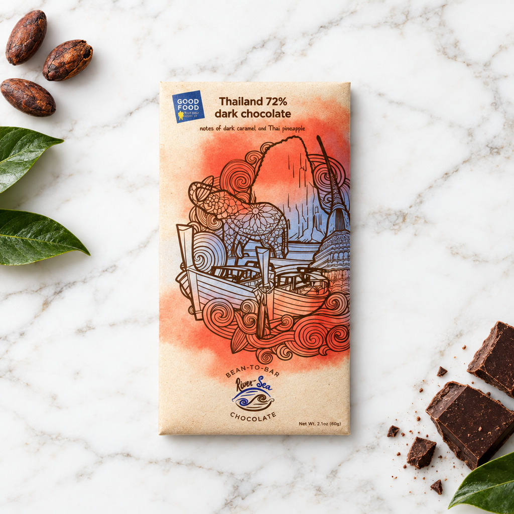 72% Thailand Dark Chocolate Bar packaging on a white marble background with cacao beans, leaves, and broken chocolate surrounding it