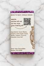The 80% Surfer's Dark Seas back of packaging from River Sea Chocolates, showing the ingredients and a QR code, on a white marble background.
