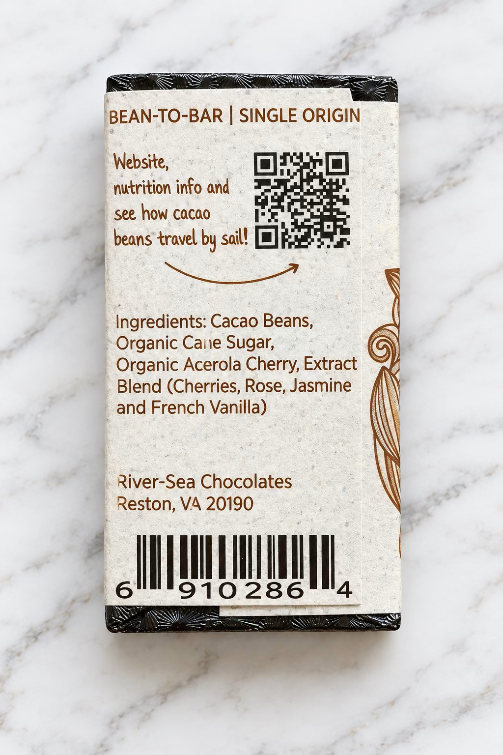 Image of the River Sea Chocolates Cherry Blossom Dark Chocolate mini packaging backside, with a QR Code and ingredients listed on a white marble background.