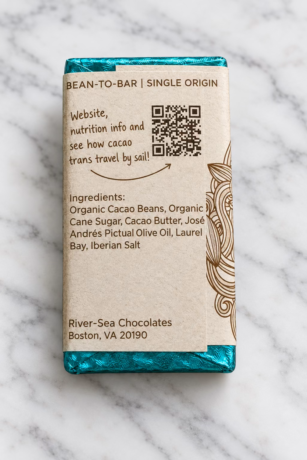 Back of the El Camino dark chocolate bar from River Sea Chocolates, showing the ingredients and QR code on a white marble background.