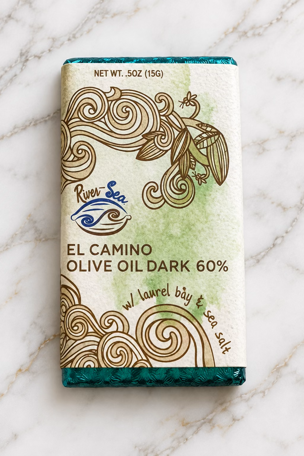 Shot of the River Sea Chocolates 60% El Camino Dark Chocolate Bar packaging on a white marble background.