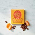 Willie's Cacao Clementina's Almonds 44% Milk Chocolate yellow box on white marble with fresh clementine slices and whole almonds, soft honeyed clementine and almonds, natural bean-to-bar, 50g