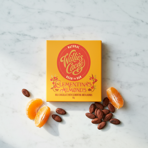 Willie's Cacao Clementina's Almonds 44% Milk Chocolate yellow box on white marble with fresh clementine slices and whole almonds, soft honeyed clementine and almonds, natural bean-to-bar, 50g