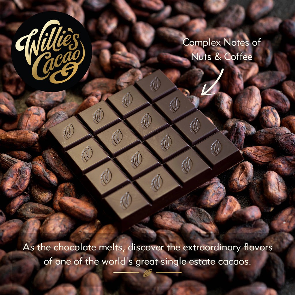 Willie's Cacao 72% Rio Caribe Gold Venezuelan Dark Chocolate bar unwrapped on cacao beans with complex notes of nuts and coffee