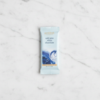 French Broad Chocolate Café Latte White Chocolate light blue packaging on white marble surface, small batch craft, crafted in Asheville NC, 1oz 28g
