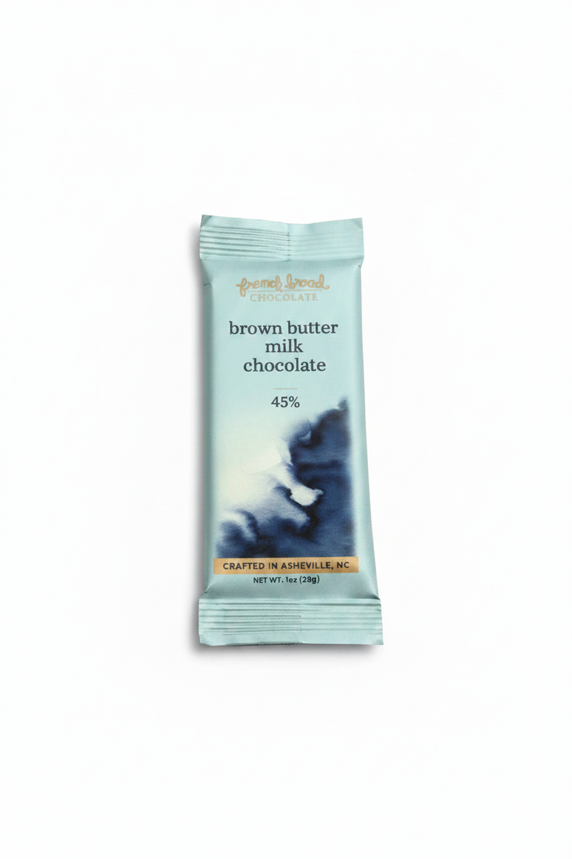 French Broad Chocolate 45% Brown Butter Milk Chocolate bar in light blue packaging with blue wave illustration standing upright on a white background, front of package facing forward